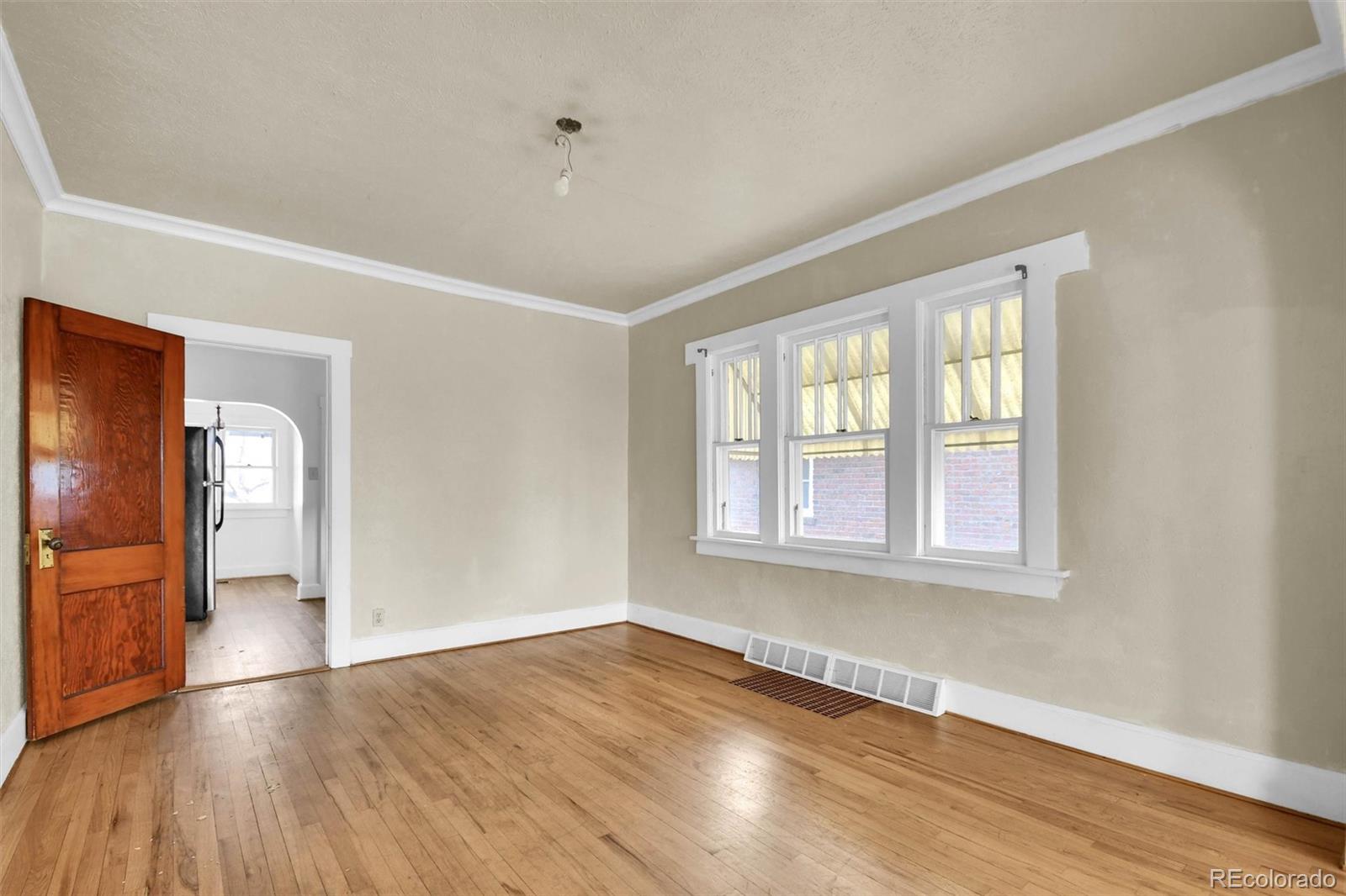 3159 West 36th Avenue Denver, CO 80211 - Photo 9 of 33 a view of empty room with wooden floor and fan