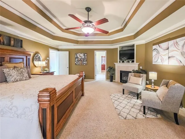 a spacious bedroom with a bed couch and window