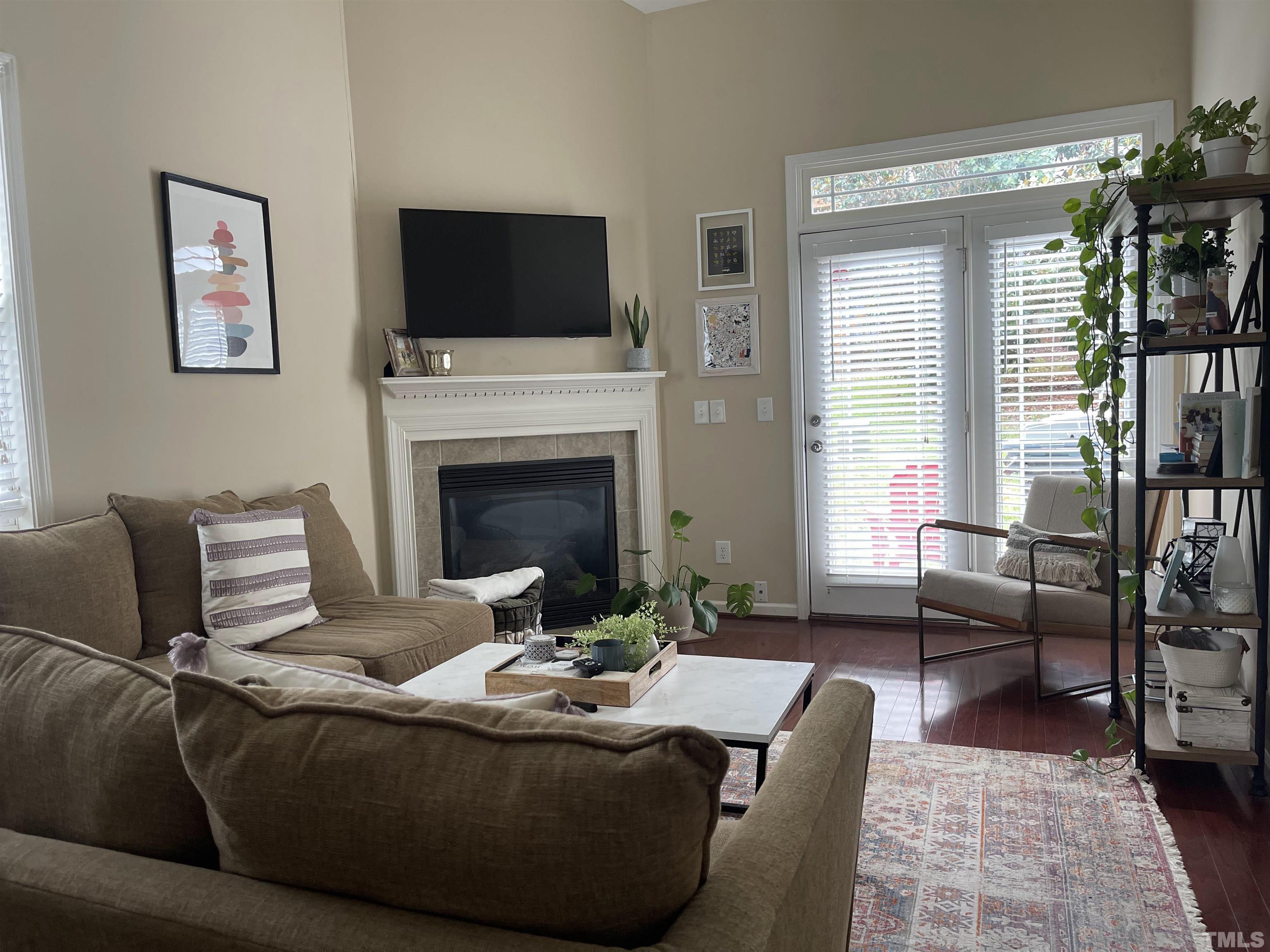 4711 Altha Street Raleigh, NC 27606 - Photo 11 of 25 a living room with furniture and a fireplace