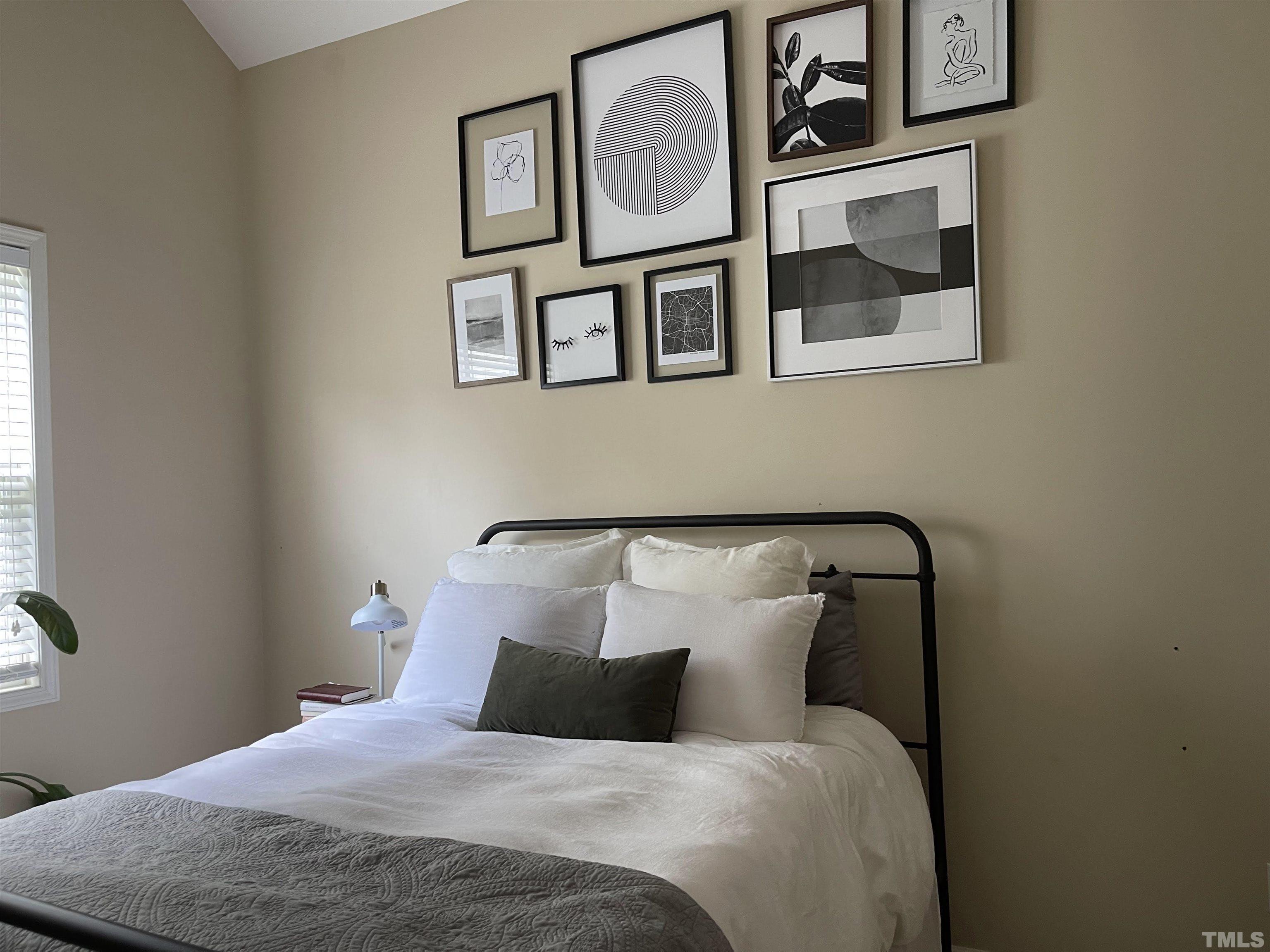 4711 Altha Street Raleigh, NC 27606 - Photo 15 of 25 a bedroom with a bed and a painting on the wall