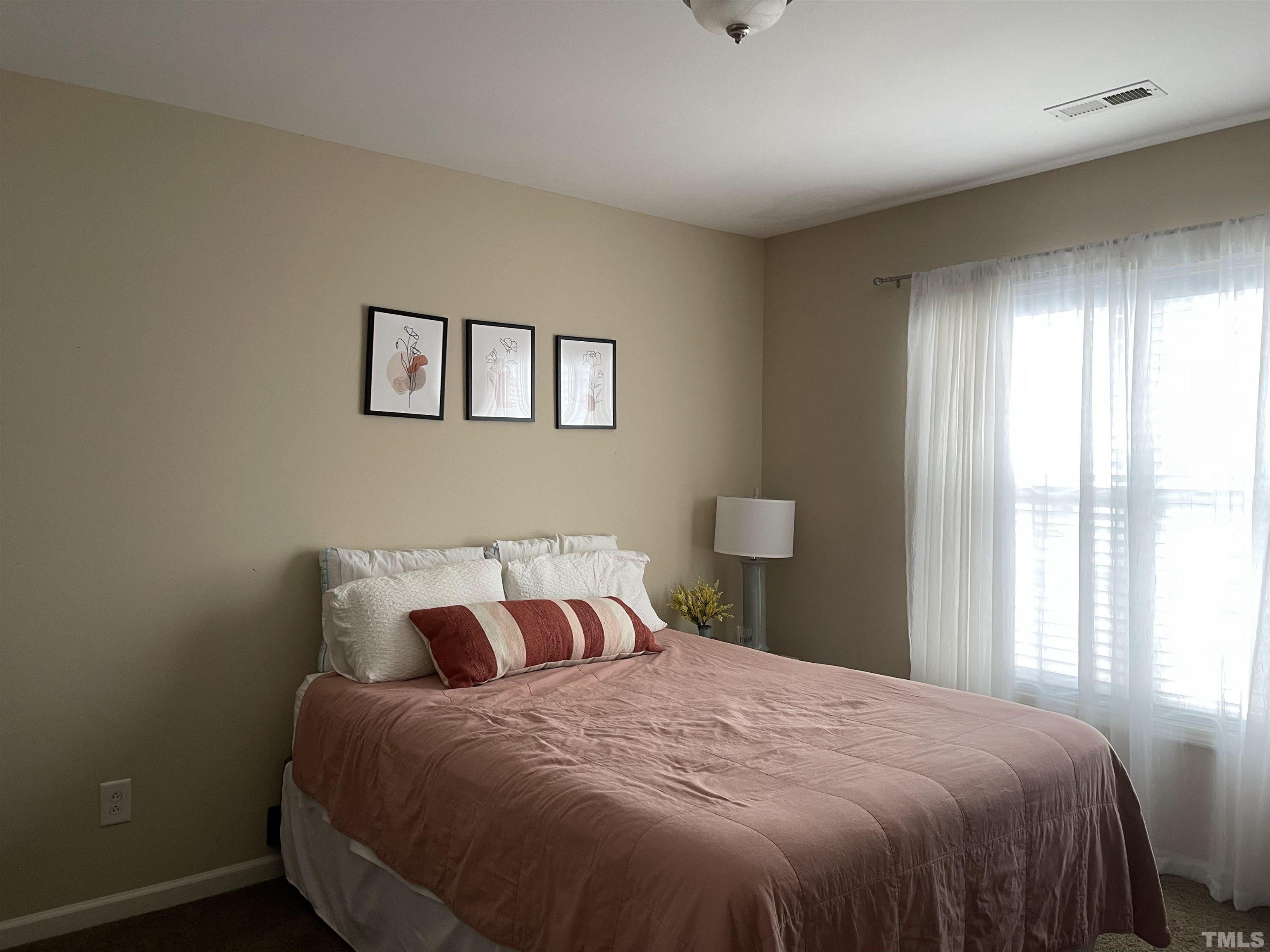 4711 Altha Street Raleigh, NC 27606 - Photo 18 of 25 a bedroom with a bed and window
