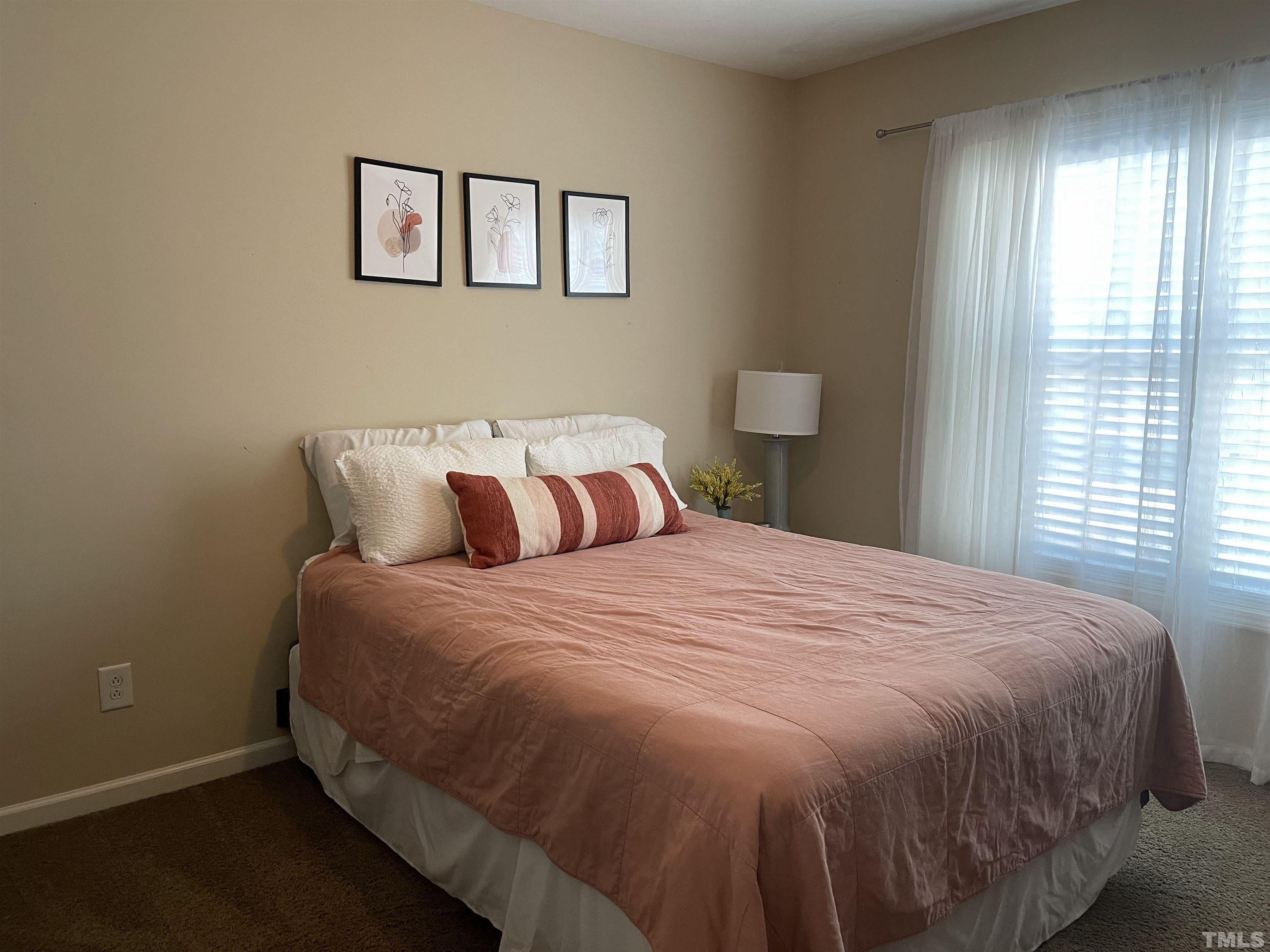 4711 Altha Street Raleigh, NC 27606 - Photo 19 of 25 a bedroom with a bed and window