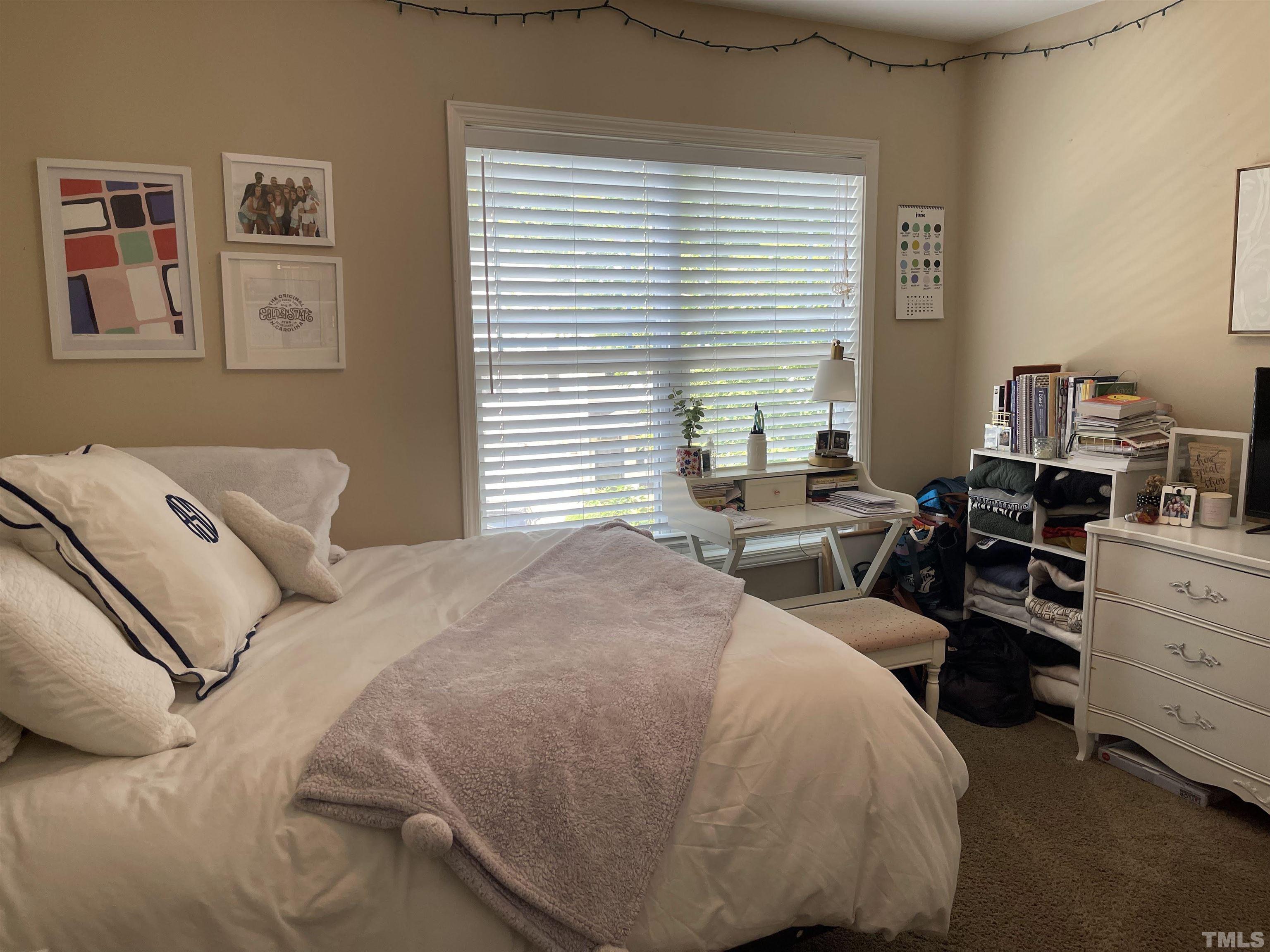 4711 Altha Street Raleigh, NC 27606 - Photo 20 of 25 a bedroom with a bed and wooden floor