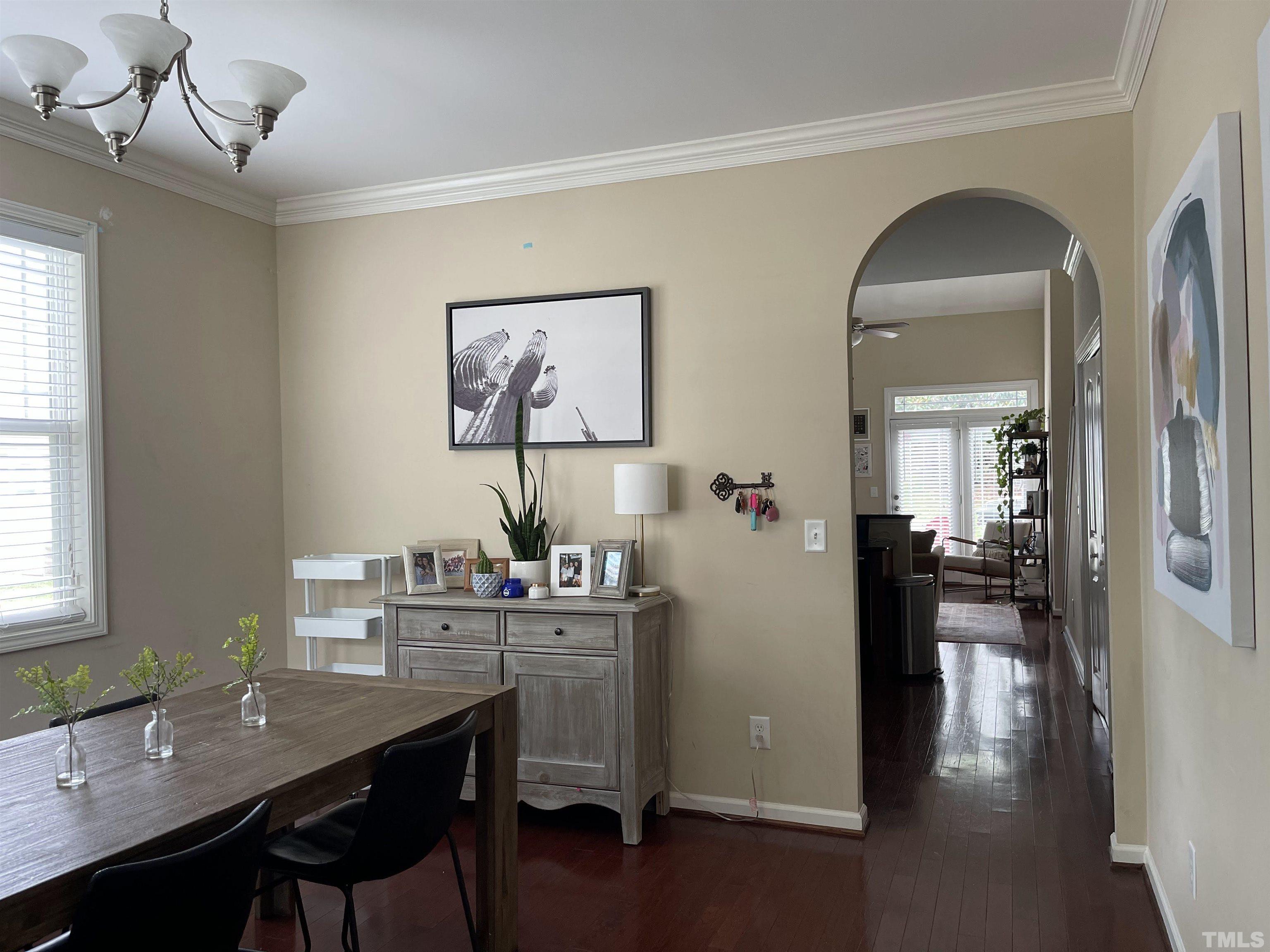 4711 Altha Street Raleigh, NC 27606 - Photo 3 of 25 a view of a workspace room with wooden floor windows and wooden floor