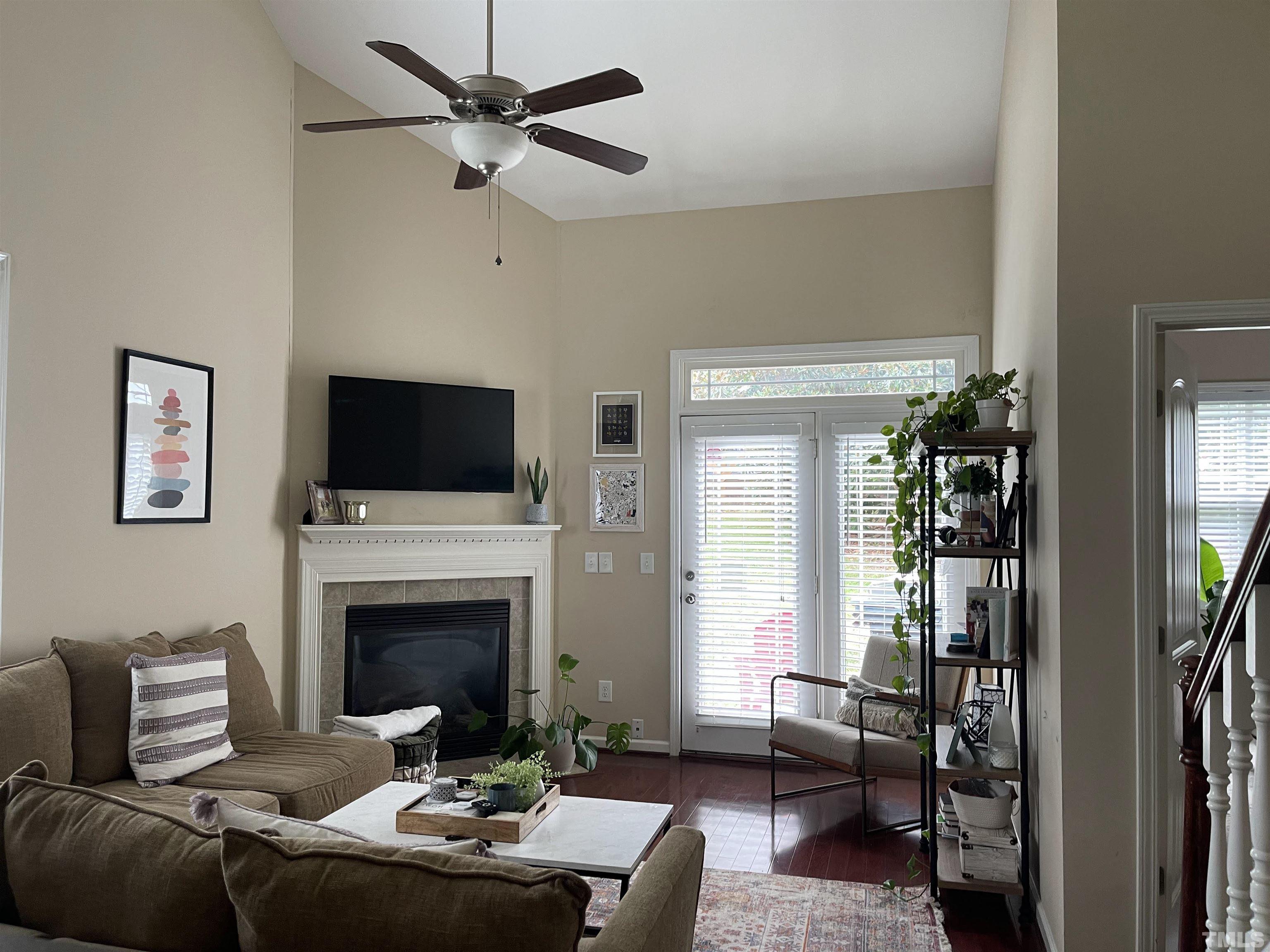4711 Altha Street Raleigh, NC 27606 - Photo 10 of 25 a living room with furniture a flat screen tv and a fireplace