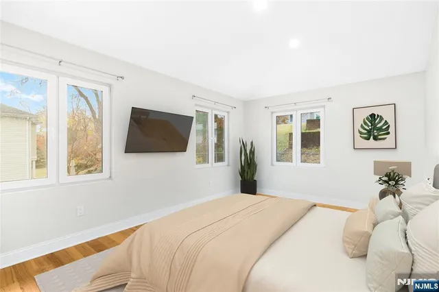 a bedroom with a large bed and a flat screen tv
