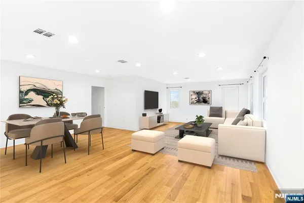 a bedroom with furniture and wooden floor