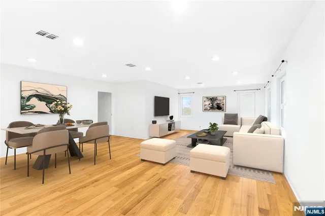 a bedroom with furniture and wooden floor