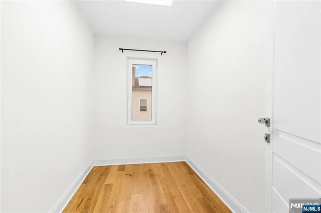 a view of a room with wooden floor and small space