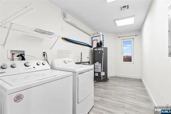 a view of washer and dryer with wooden floor