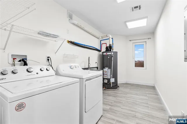 a view of washer and dryer with wooden floor