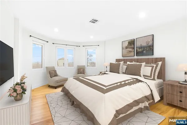 a spacious bedroom with a bed and a couch