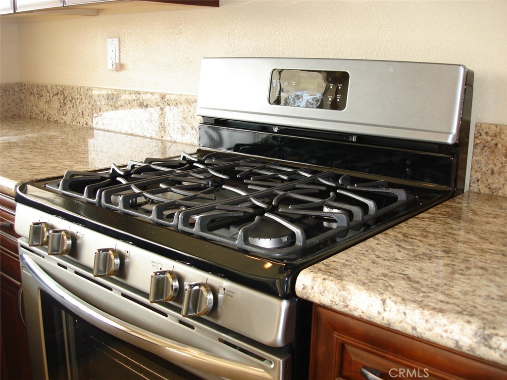 19584 Shadow Glen Circle Porter Ranch, CA 91326 - Photo 15 of 72 a close up of a stove top oven sitting inside of a kitchen