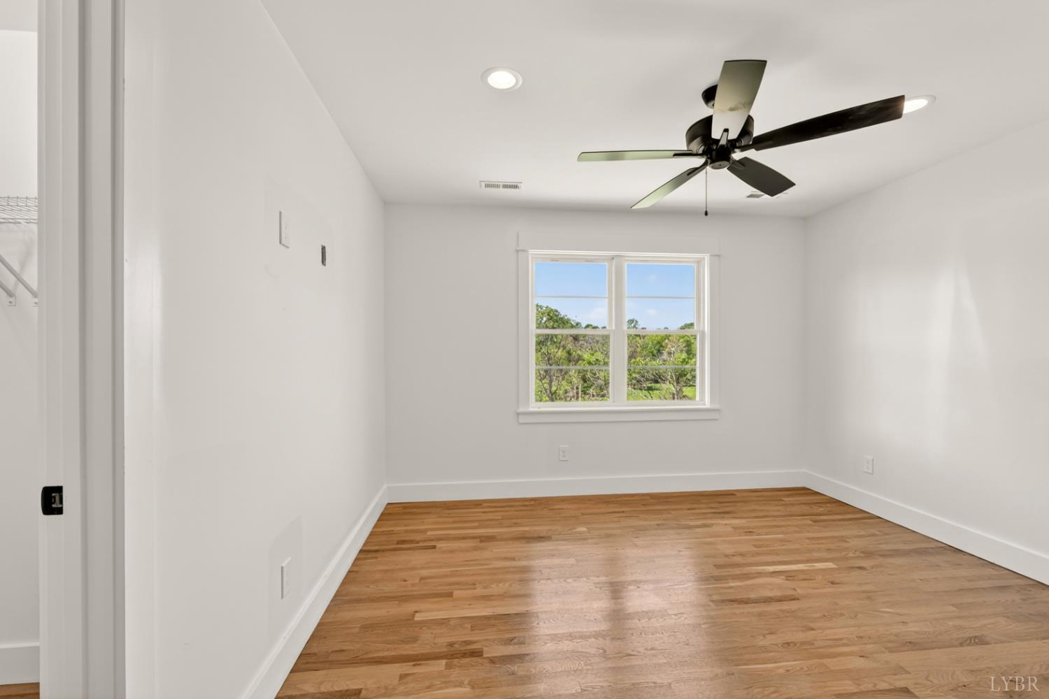 1488 Deer Hollow Road Forest, VA 24551 - Photo 44 of 68 a view of empty room with wooden floor and fan