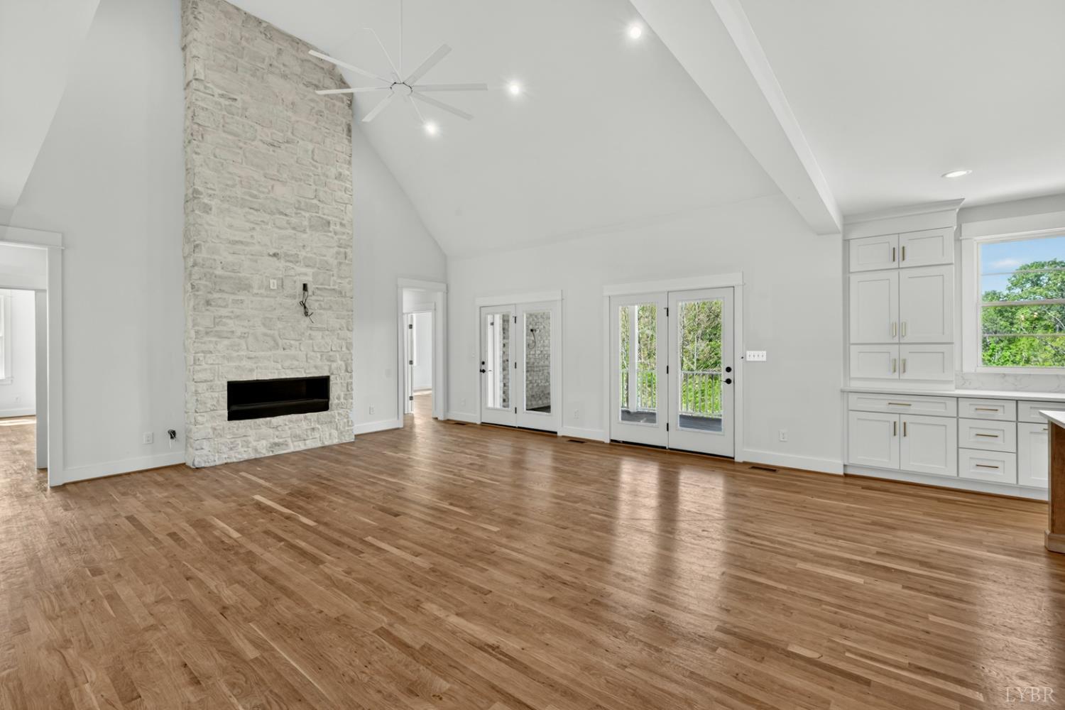 1488 Deer Hollow Road Forest, VA 24551 - Photo 9 of 68 a view of empty room with wooden floor and fireplace