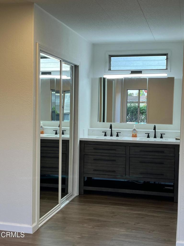 103 Gay Drive, Unit 103 Ventura, CA 93003 - Photo 11 of 17 a bathroom with a double vanity sink and a large mirror