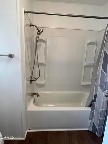 a bathroom with a bathtub and a shower