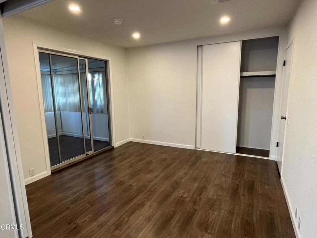 103 Gay Drive, Unit 103 Ventura, CA 93003 - Photo 13 of 17 a view of an empty room with wooden floor