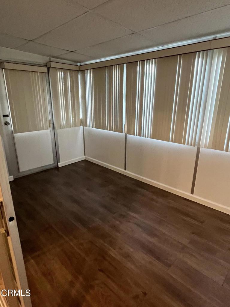 103 Gay Drive, Unit 103 Ventura, CA 93003 - Photo 14 of 17 a view of an empty room with wooden floor and a window
