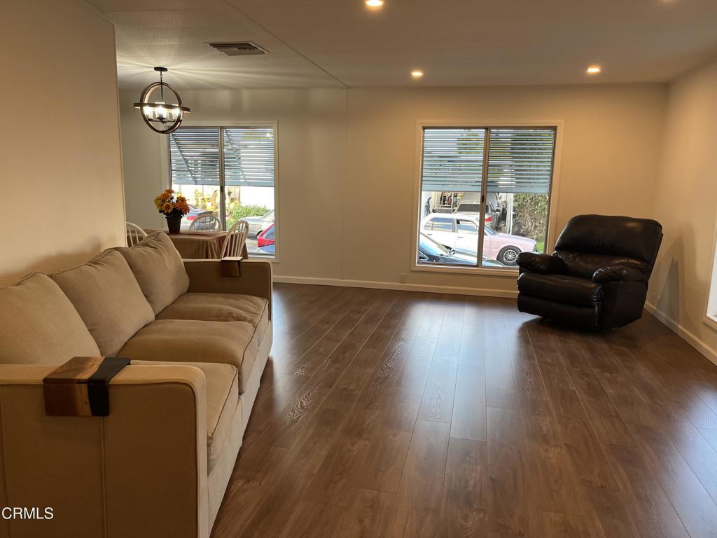 103 Gay Drive, Unit 103 Ventura, CA 93003 - Photo 2 of 17 a living room with furniture and a wooden floor