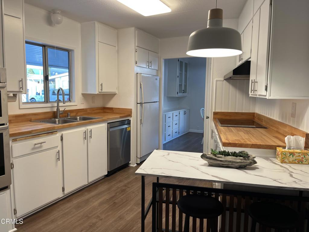 103 Gay Drive, Unit 103 Ventura, CA 93003 - Photo 5 of 17 a kitchen with a sink cabinets and wooden floor