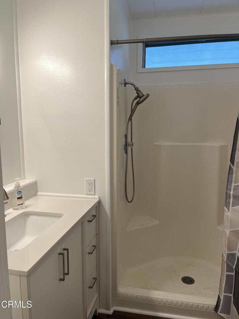 103 Gay Drive, Unit 103 Ventura, CA 93003 - Photo 8 of 17 a bathroom with a sink a mirror and a shower