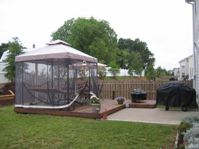 148 Solheim Lane Raleigh, NC 27603 - Photo 12 of 12 a view of a garden with a small deck and a garden