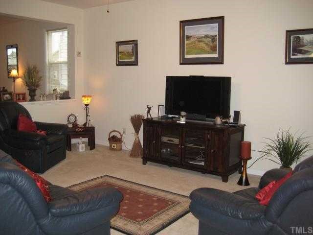 148 Solheim Lane Raleigh, NC 27603 - Photo 3 of 12 a living room with furniture and a flat screen tv