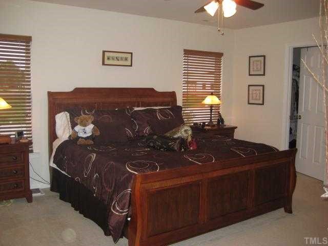 148 Solheim Lane Raleigh, NC 27603 - Photo 6 of 12 a bed sitting in a bedroom next to a window