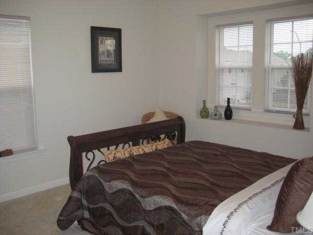 148 Solheim Lane Raleigh, NC 27603 - Photo 7 of 12 a bedroom with a bed and a window