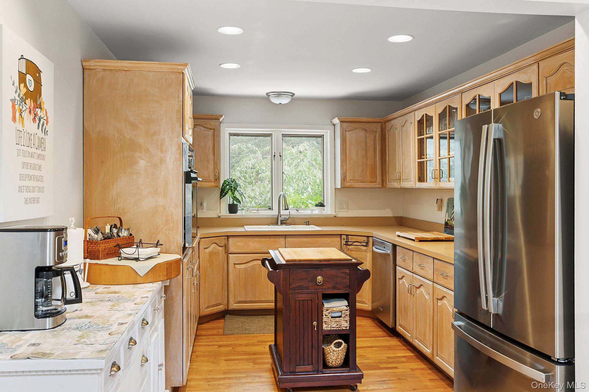 624 Noyack Road Southampton, NY 11968 - Photo 6 of 15 a kitchen with stainless steel appliances granite countertop a refrigerator a sink dishwasher a stove and white countertops with wooden floor