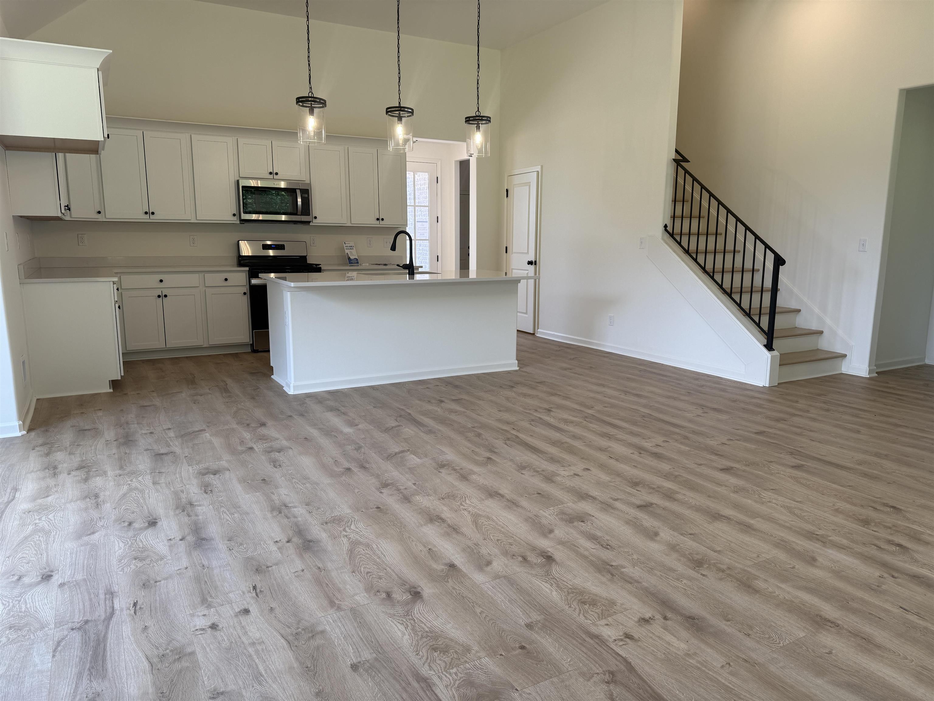85 Ridgefield Drive Oakland, TN 38060 - Photo 2 of 12 a kitchen with stainless steel appliances granite countertop a stove a sink and a refrigerator