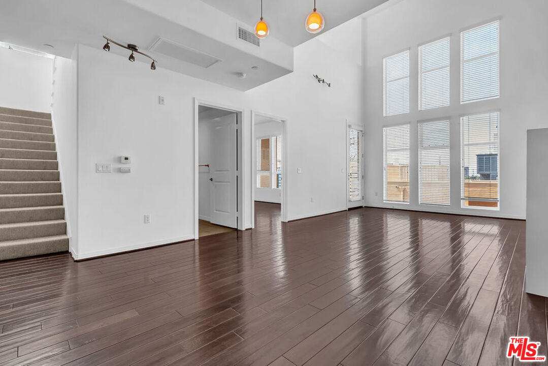 4050 Glencoe Avenue, Unit 405 Marina del Rey, CA 90292 - Photo 11 of 42 a view of an empty room with wooden floor and a window
