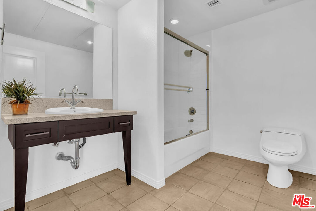 4050 Glencoe Avenue, Unit 405 Marina del Rey, CA 90292 - Photo 15 of 42 a bathroom with a sink a toilet and shower