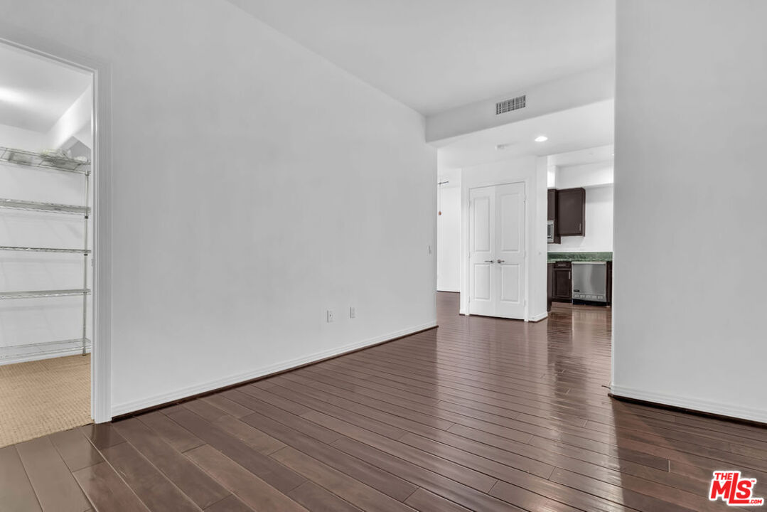 4050 Glencoe Avenue, Unit 405 Marina del Rey, CA 90292 - Photo 17 of 42 a view of empty room with wooden floor and kitchen