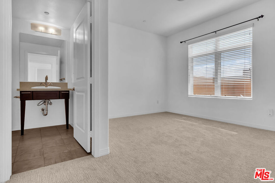 4050 Glencoe Avenue, Unit 405 Marina del Rey, CA 90292 - Photo 19 of 42 a view of hallway with a sink and a large mirror