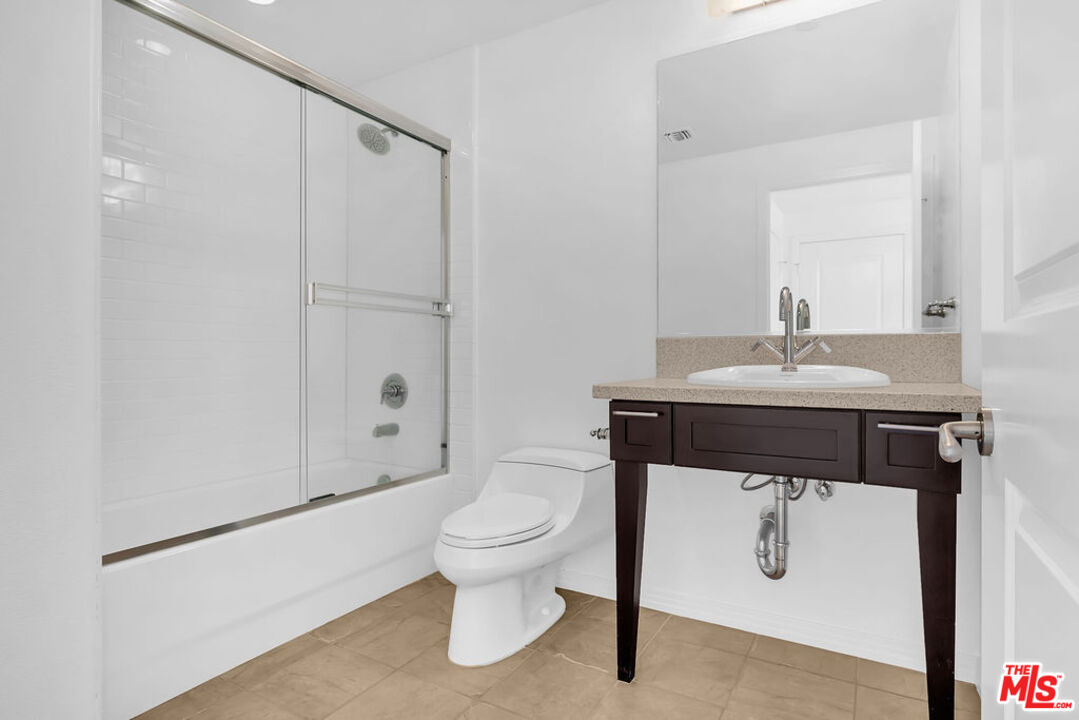 4050 Glencoe Avenue, Unit 405 Marina del Rey, CA 90292 - Photo 21 of 42 a bathroom with a sink a toilet and shower
