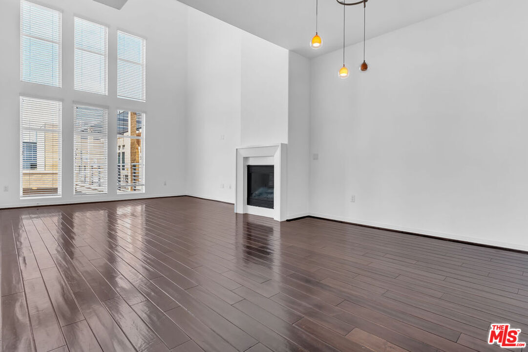 4050 Glencoe Avenue, Unit 405 Marina del Rey, CA 90292 - Photo 3 of 42 a view of an empty room with wooden floor and a window