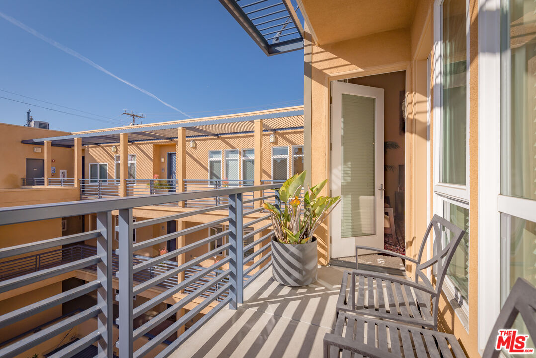 4050 Glencoe Avenue, Unit 405 Marina del Rey, CA 90292 - Photo 32 of 42 a view of a balcony with chairs and wooden floor
