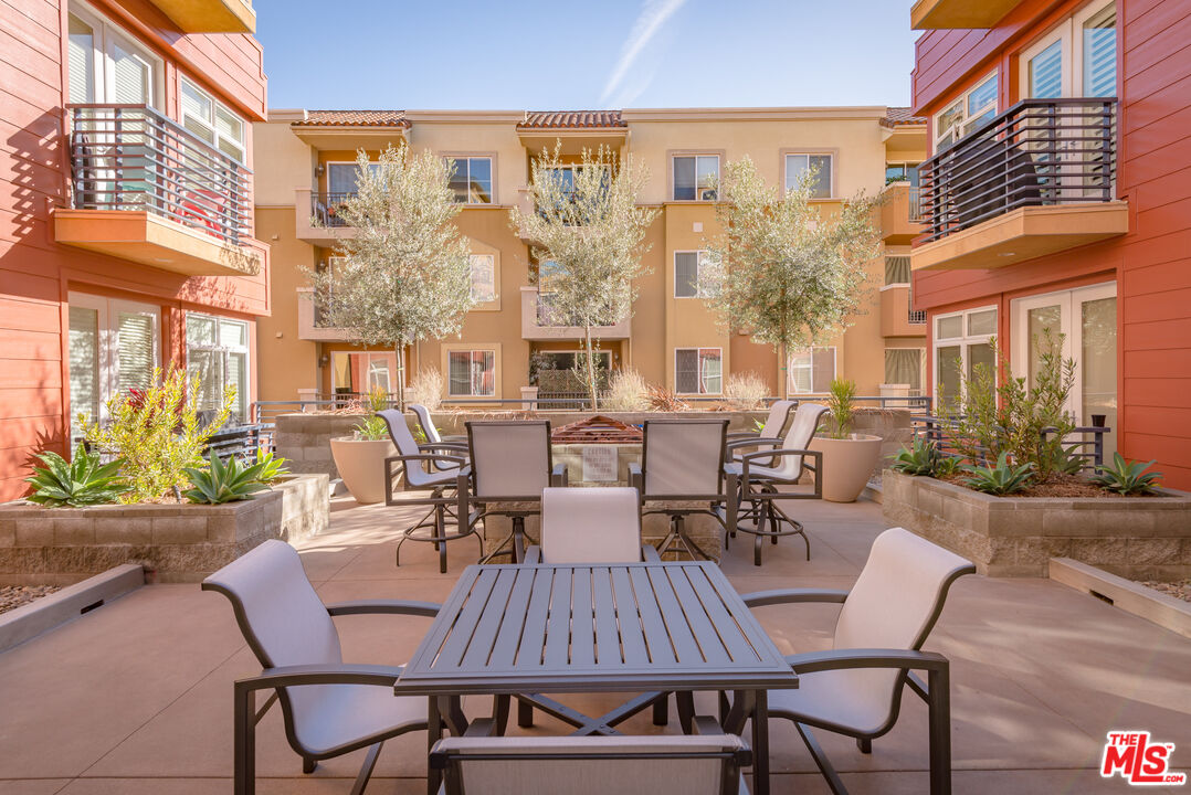 4050 Glencoe Avenue, Unit 405 Marina del Rey, CA 90292 - Photo 38 of 42 a view of a patio with a dining table and chairs with plants