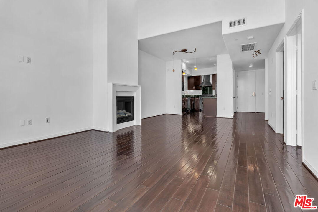 4050 Glencoe Avenue, Unit 405 Marina del Rey, CA 90292 - Photo 5 of 42 a view of a livingroom with wooden floor and a fireplace