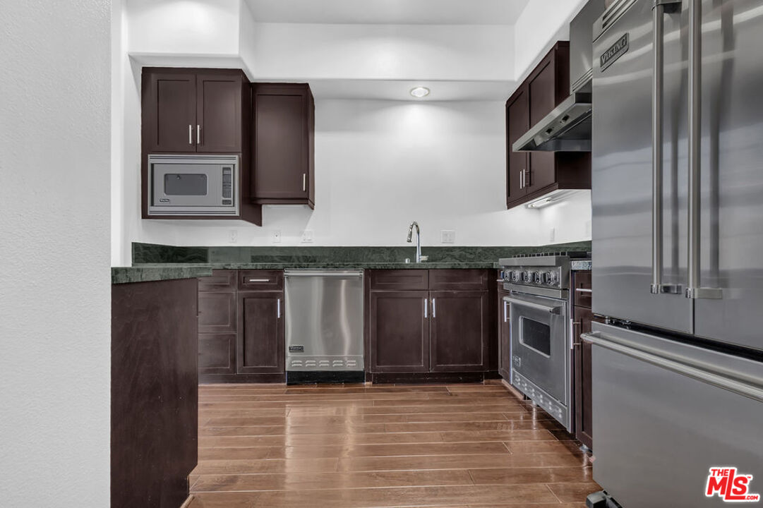 4050 Glencoe Avenue, Unit 405 Marina del Rey, CA 90292 - Photo 7 of 42 a kitchen with stainless steel appliances granite countertop a stove a sink and a refrigerator