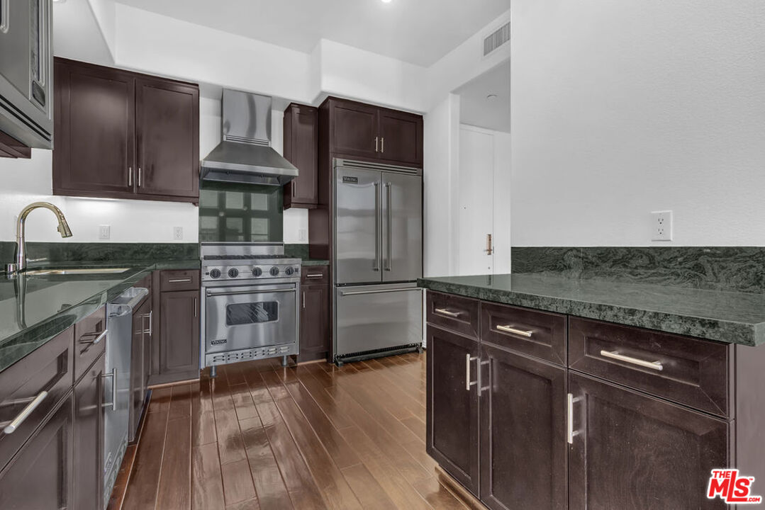 4050 Glencoe Avenue, Unit 405 Marina del Rey, CA 90292 - Photo 8 of 42 a kitchen with stainless steel appliances granite countertop a stove and a refrigerator