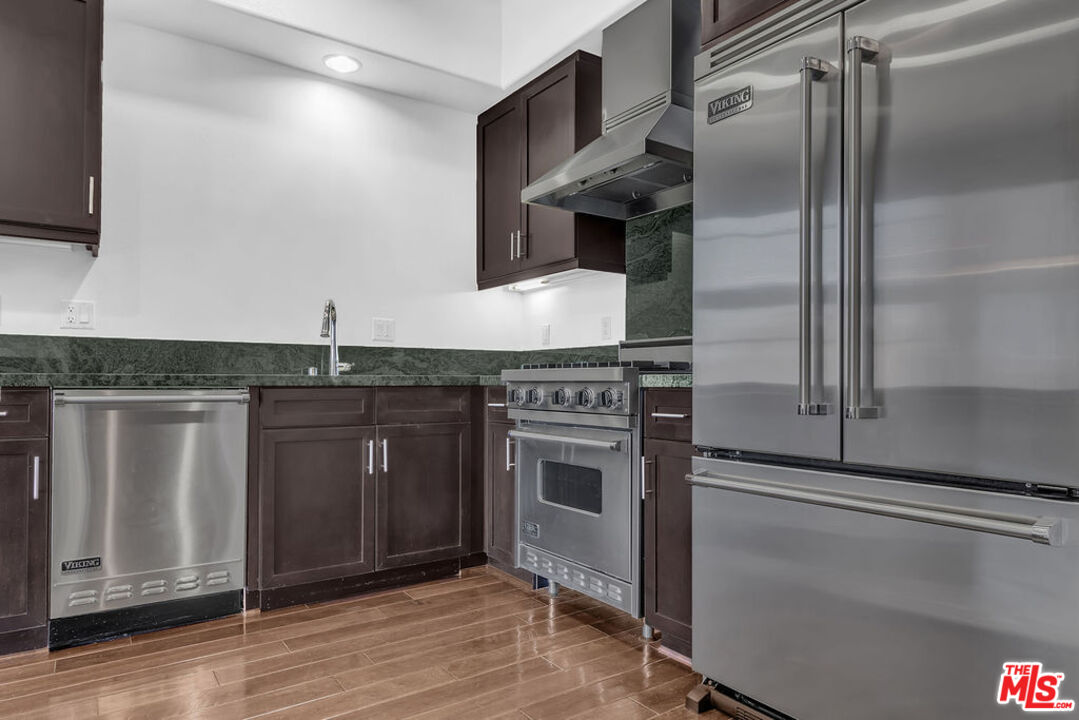 4050 Glencoe Avenue, Unit 405 Marina del Rey, CA 90292 - Photo 9 of 42 a kitchen with stainless steel appliances granite countertop a sink and a refrigerator