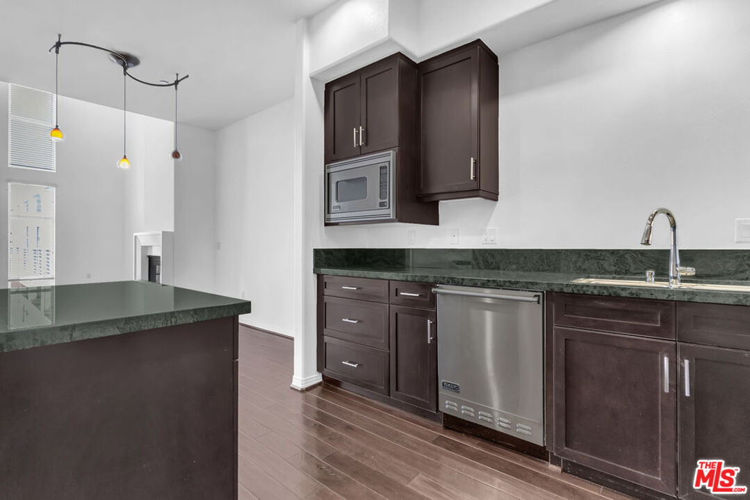4050 Glencoe Avenue, Unit 405 Marina del Rey, CA 90292 - Photo 10 of 42 a kitchen with granite countertop a sink and cabinets