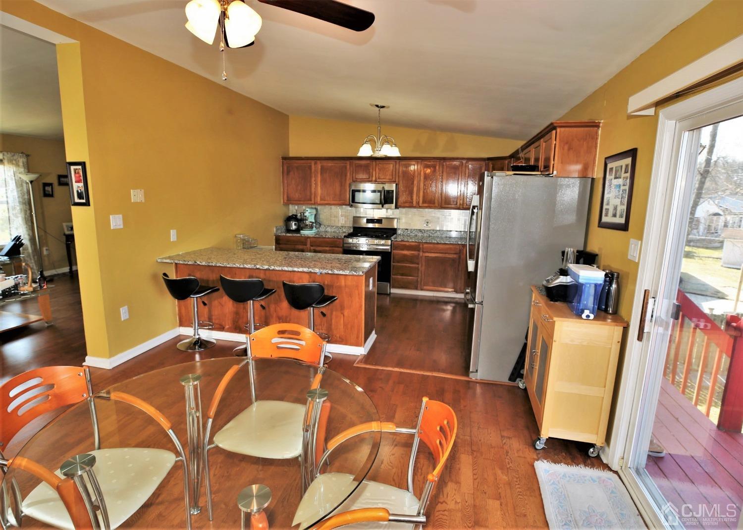 148 Kendall Road Kendall Park, NJ 08824 - Photo 12 of 47 a kitchen with stainless steel appliances granite countertop a refrigerator a sink dishwasher and a stove with wooden floor