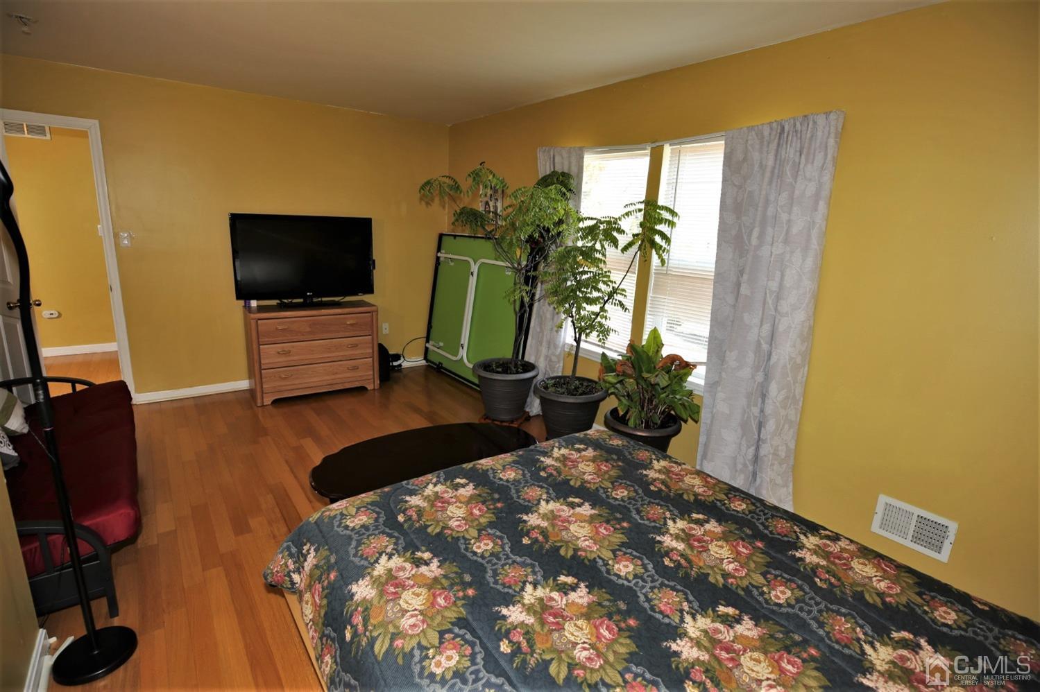 148 Kendall Road Kendall Park, NJ 08824 - Photo 29 of 47 a bedroom with a bed window and flat screen tv