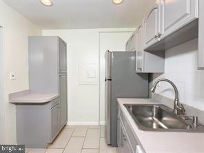 614 Sligo Avenue, Unit 405 Silver Spring, MD 20910 - Photo 11 of 31 a kitchen with a sink and a refrigerator