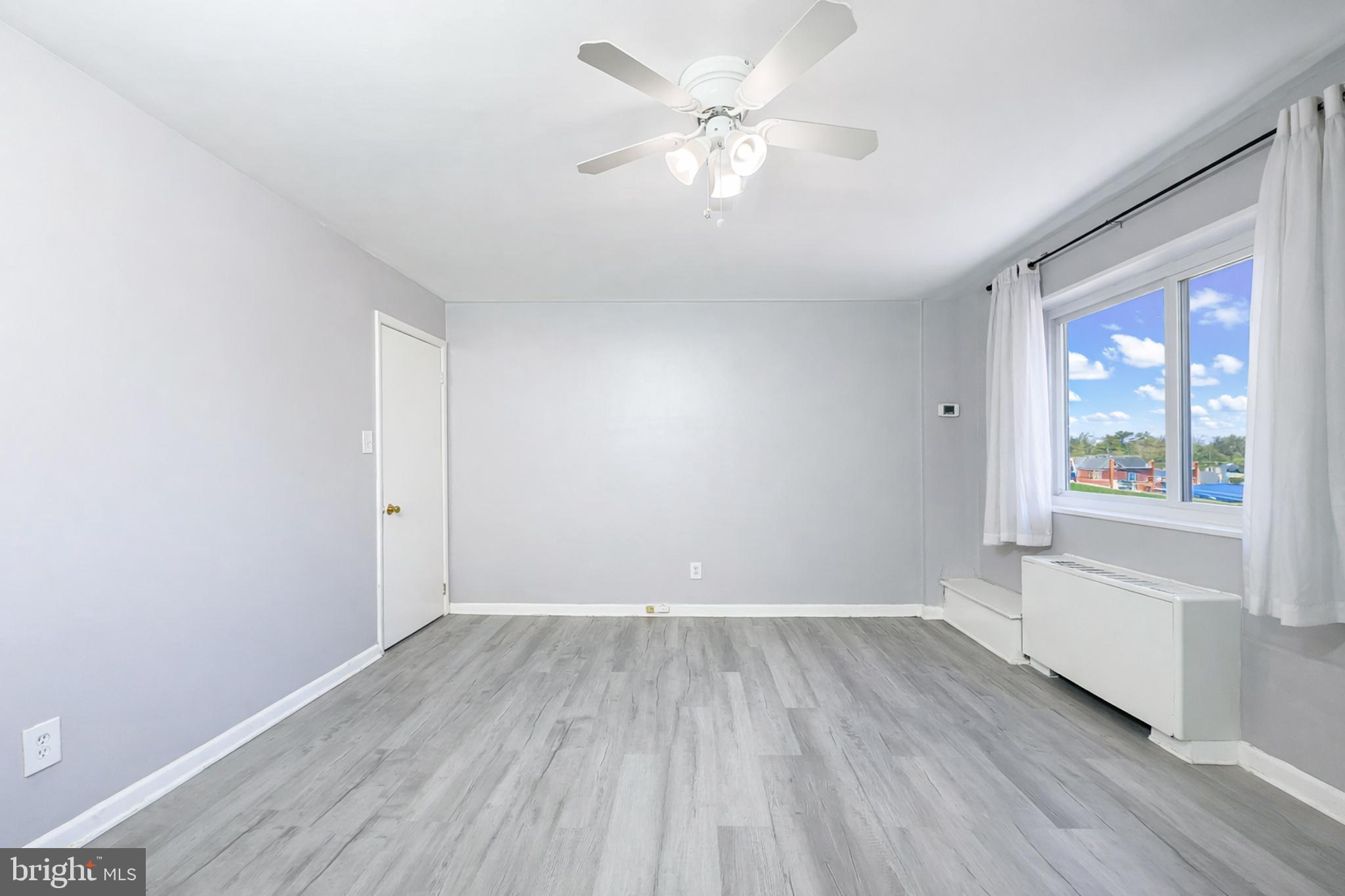 614 Sligo Avenue, Unit 405 Silver Spring, MD 20910 - Photo 15 of 31 wooden floor in an empty room with a window