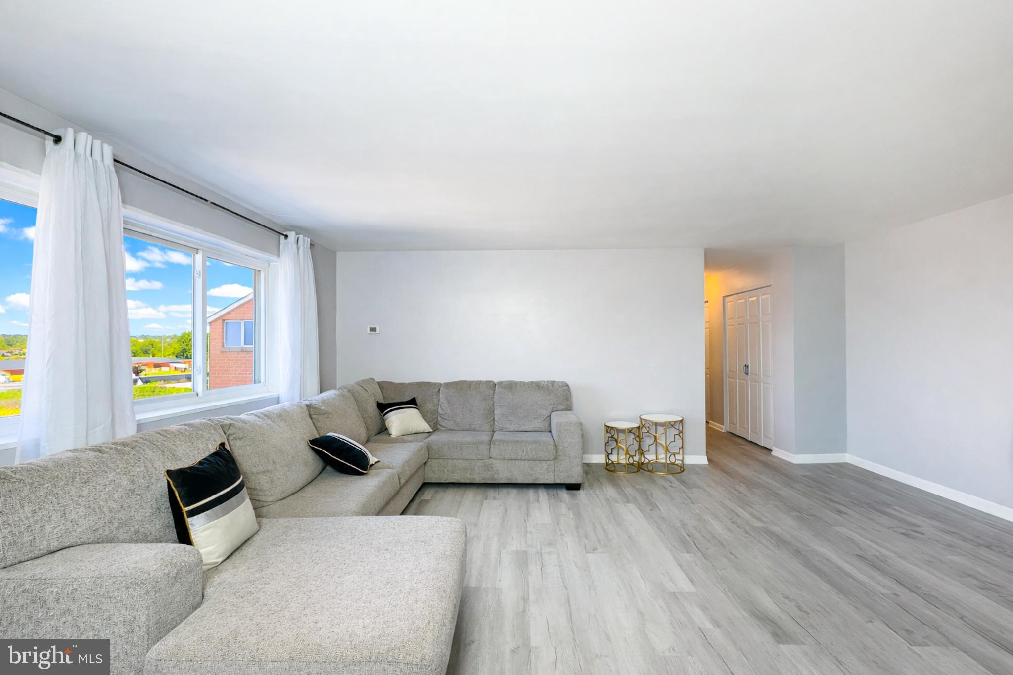 614 Sligo Avenue, Unit 405 Silver Spring, MD 20910 - Photo 4 of 31 a living room with furniture and a wooden floor